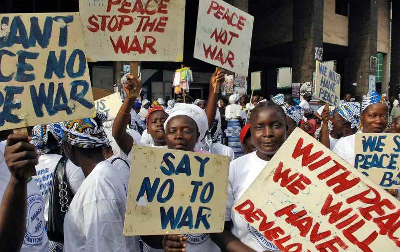 Women in the street protesting against war.