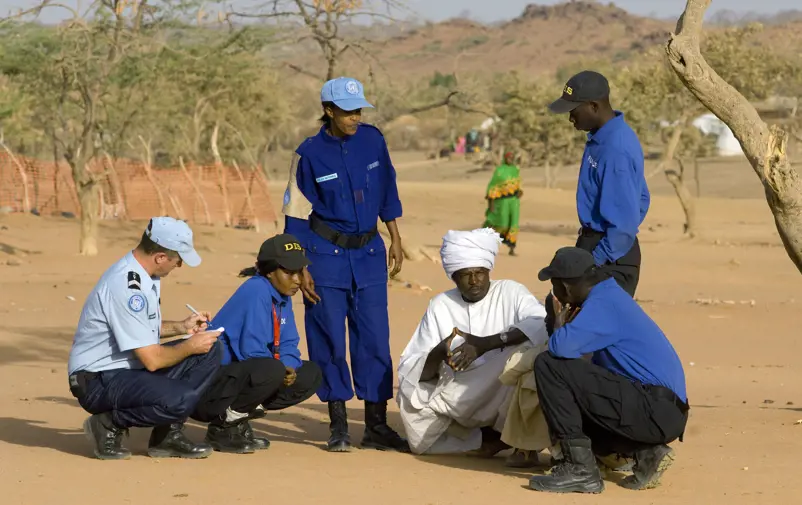 UN Police Officers interviewing refugees.