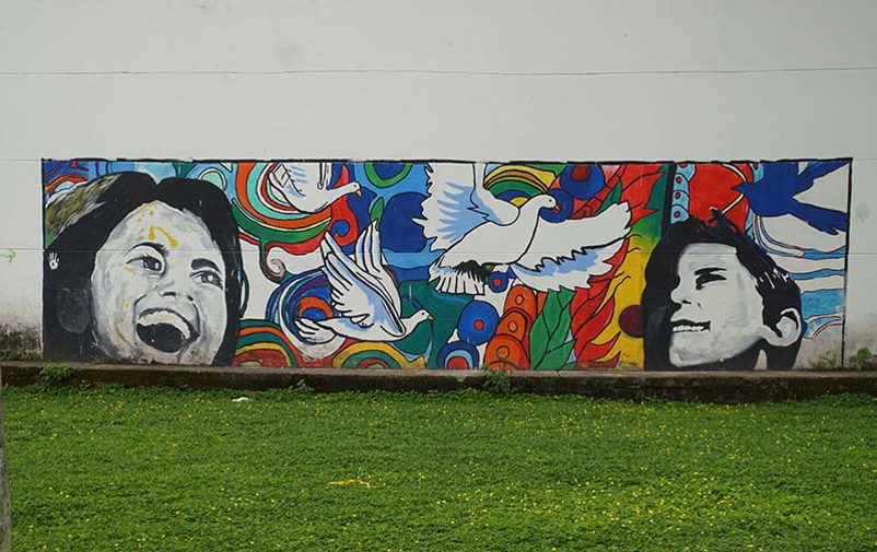 Mural painting in Colombia, showing the faces of two children looking at peace doves.